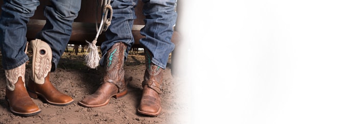 Two cowboys wearing brown and tan Tony Lama boots.